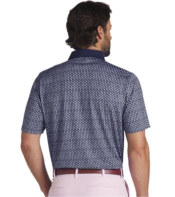 Puma Mens AP MATTR Iced Tea Golf Polo Shirt Model back in Deep Navy with a unique, intricate iced tea graphic set pattern of diagonal rows of tiny ice tea glasses with a slice of lemon and a straw to create an all over pattern effect.