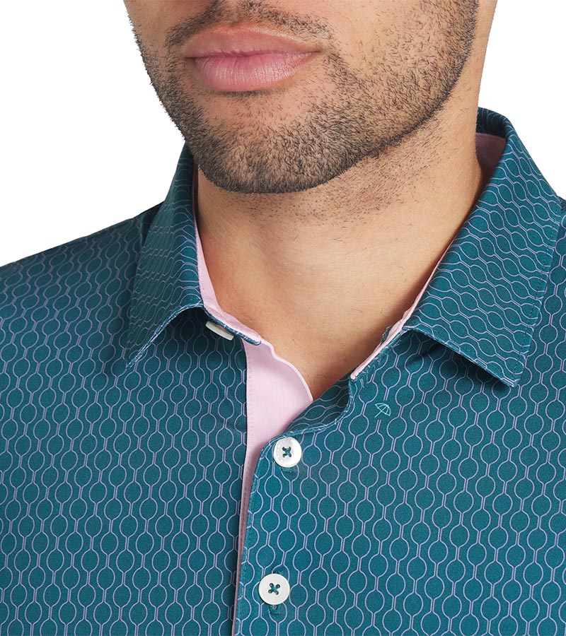 Puma Mens AP Citrus Golf Polo Shirt closeup of collar in Cold Green / Pale Pink with a simple all-over linear geometric pattern. Has a contrast pink color on the inside of the collar as well as the inside of the 3 button placket that elevates the overall crisp look.