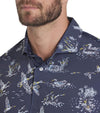 Puma Mens MATTR Flock Golf Polo closeup of collar in Deep Navy / Pele Yellow stripe in a duck wild life print on navy. 