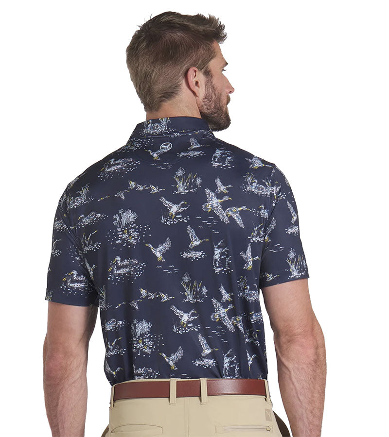 Puma Mens MATTR Flock Golf Polo Model Back in Deep Navy / Pele Yellow stripe in a duck wild life print on navy.