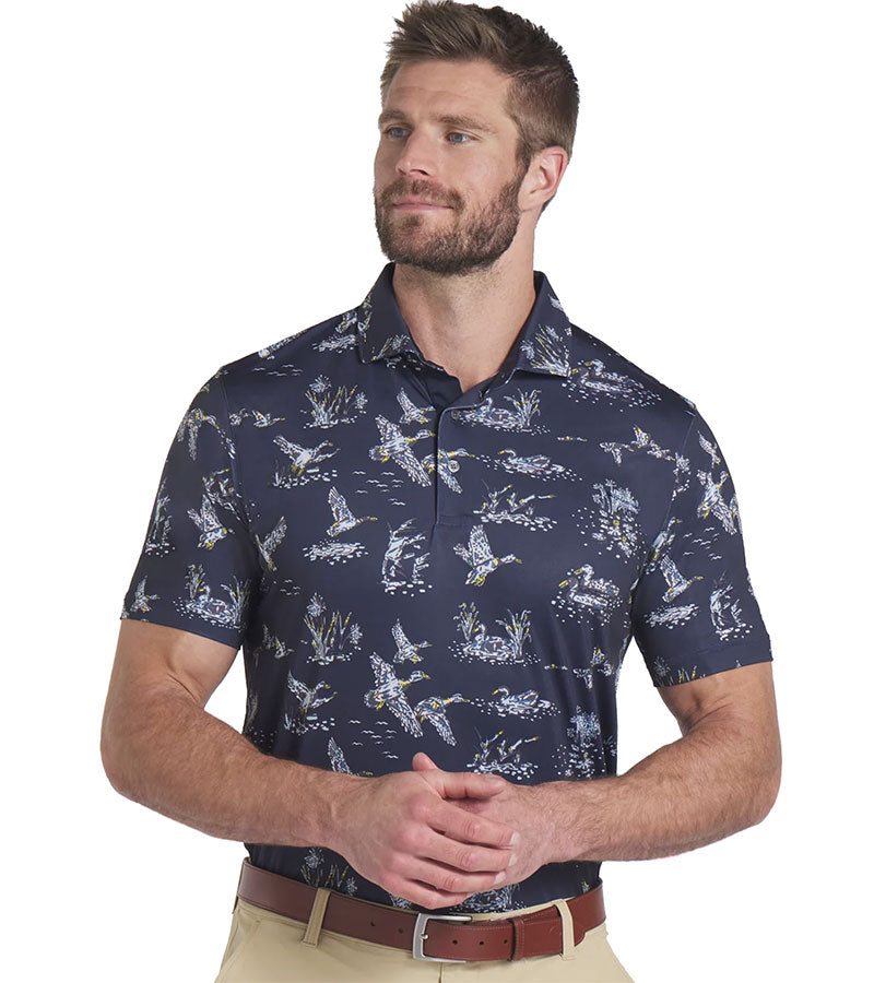 Puma Mens MATTR Flock Golf Polo Model Front in Deep Navy / Pele Yellow in a duck wild life print on navy.