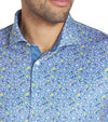 Puma Mens MATTR Soto Golf Polo Shirt closeup of collar in Blue Horizon / Pele Yellow with a tiny all-over floral print.