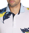 Puma Mens MATTR Terrance Golf Polo Shirt closeup of collar in Silver Sky with a widely spaced group of tropical flowers & leaves on a small set geometric white on white background.