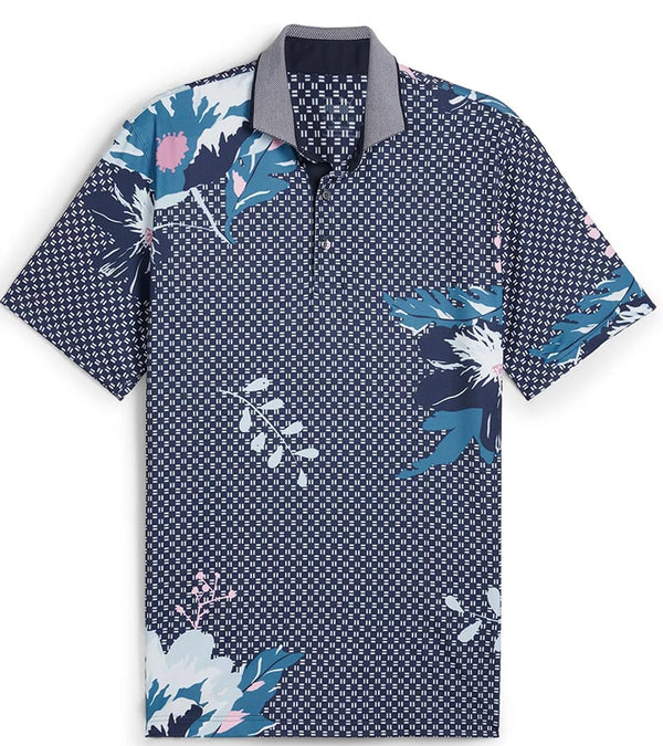 Puma Mens MATTR Terrance Golf Polo Shirt -front in Deep Navy with a widely spaced group of tropical flowers & leaves on a small set geometric navy background.