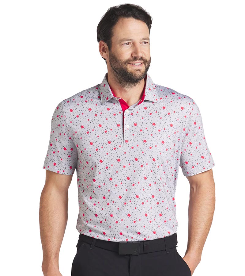 Puma Mens Canada Maple Dot Golf Polo Shirt Model Front in Ash Gray / Strong Red with a spaced all-over design of small maple leaves floating over a light grey background with white & charcoal dots. The inner collar and inner placket of the 3 button placket are red adding a stylish accent.