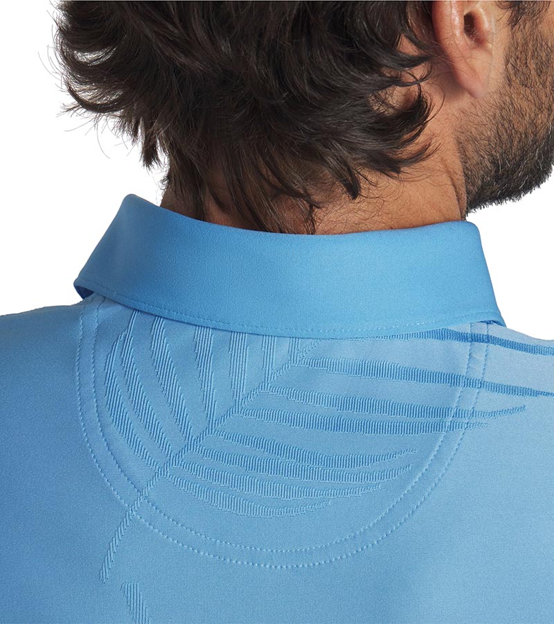 Puma x PTC Jacquard Golf Polo Shirt closeup of collar back in Regal Blue has large palm fronds widely spaced in a subtle monochromatic jacquard weave, a classis polo collar, and a 3 button placket.