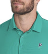 Puma x PTC Jacquard Golf Polo Shirt closeup of collar in Sparkling Green has large palm fronds widely spaced in a subtle monochromatic jacquard weave, a classis polo collar, and a 3 button placket.