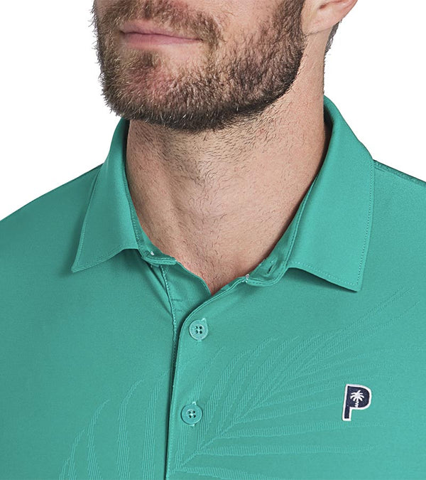 Puma x PTC Jacquard Golf Polo Shirt closeup of collar in Sparkling Green has large palm fronds widely spaced in a subtle monochromatic jacquard weave, a classis polo collar, and a 3 button placket.