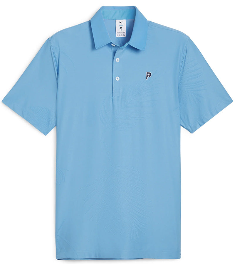 Puma x PTC Jacquard Golf Polo Shirt  - front in Regal Blue has large palm fronds widely spaced in a subtle monochromatic jacquard weave, a classis polo collar, and a 3 button placket.