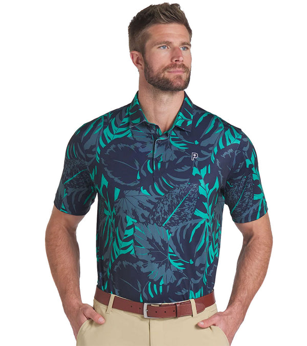 Puma Mens x PTC Palm Glitch Golf Polo Shirt Model - front in Deep Navy / Sparkling Green has an all over pattern of large lush palm fronds, a classis polo collar, and a 3 button placket.