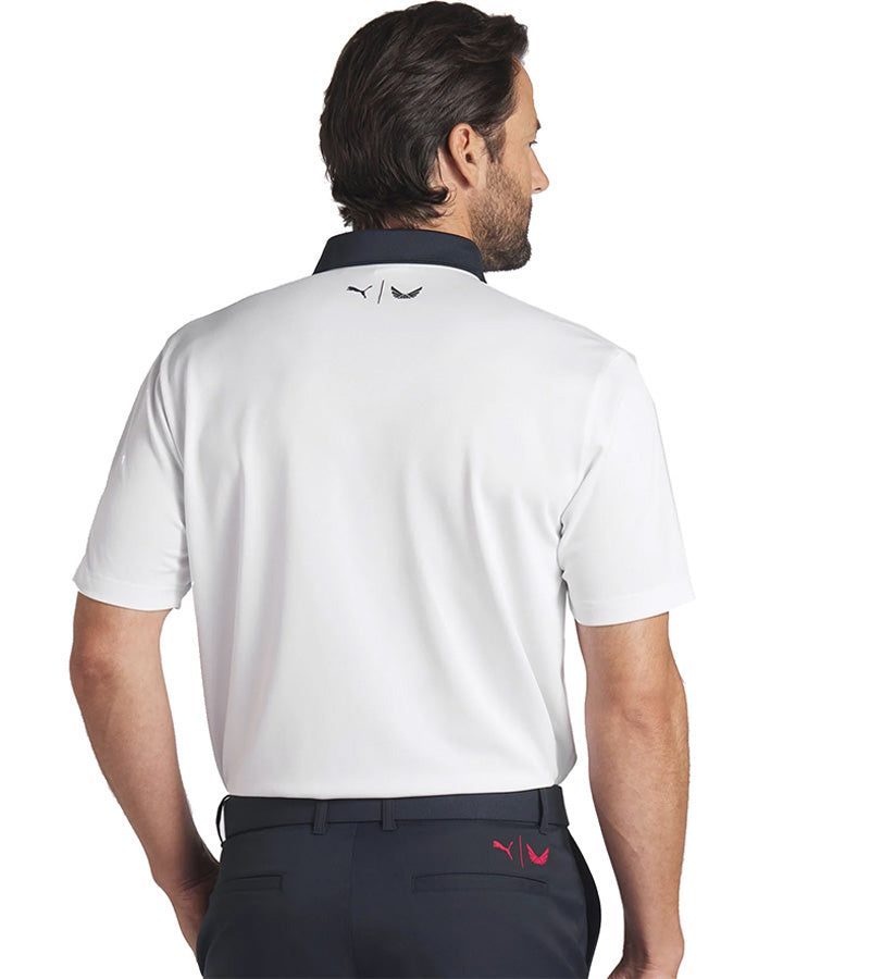 Puma Mens Volition Eagle Golf Polo Shirt Model back in White Glow / Deep Navy with a patriotic theme design of an eagle stripe graphic across the front featuring the bald eagle against a band of red and white stripes. The accent color of the inner collar and 3 button placket gives a pop to the all over look.