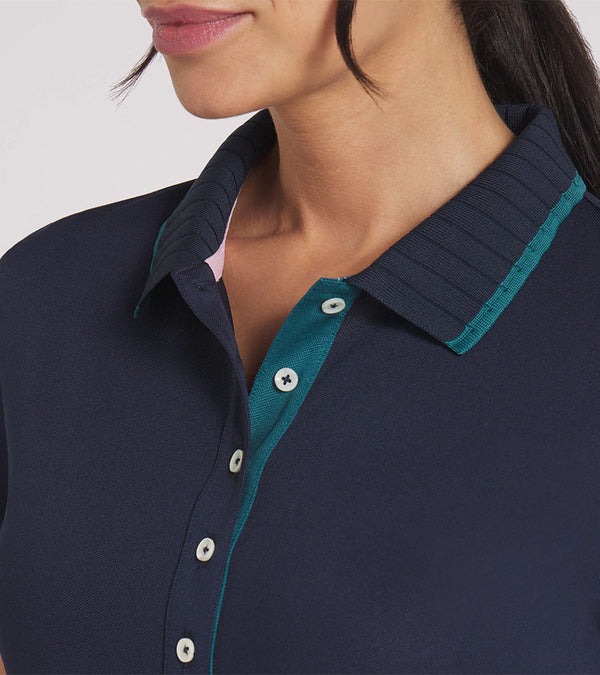 Puma Womens AP Pique Golf Polo Shirt Short Sleeve shirt in solid Deep Navy
 with a closeup of the neckline featuring a classic ribbed collar with dark turquoise contrast piping and a five-button inner placket.