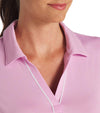 Puma Womens CLOUDSPUN Piped Golf Polo Shirt / Short Sleeve in Pink Icing with a closeup of the classic collar neckline featuring piped detailing at the V neckline adding a touch of sophistication to the overall design.