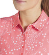 Puma Womens MATTR Hadley Sleeveless Golf Polo Shirt in Salmon with a closeup of the neckline featuring a delicate tiny white floral & dots print with a classic polo collar and 5 button placket for a sophisticated, sporty look.