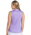 Puma Womens MATTR Hadley Sleeveless Golf Polo Shirt model back in Lavender Alert featuring a delicate tiny white floral & dots print with a classic polo collar and 5 button placket for a sophisticated, sporty look. 