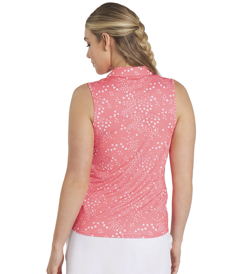 Puma Womens MATTR Hadley Sleeveless Golf Polo Shirt model back in Salmon featuring a delicate tiny white floral & dots print with a classic polo collar and 5 button placket for a sophisticated, sporty look. 