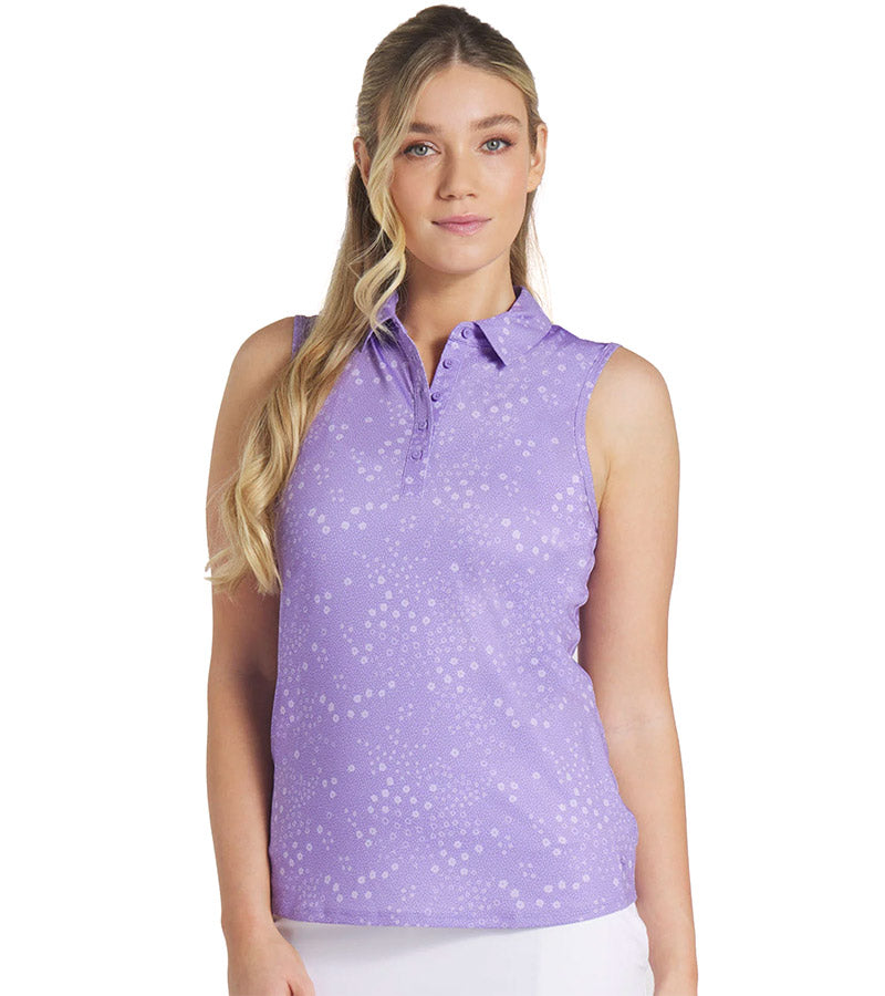 Puma Womens MATTR Hadley Sleeveless Golf Polo Shirt model front in Lavender Alert featuring a delicate tiny white floral & dots print with a classic polo collar and 5 button placket for a sophisticated, sporty look. 