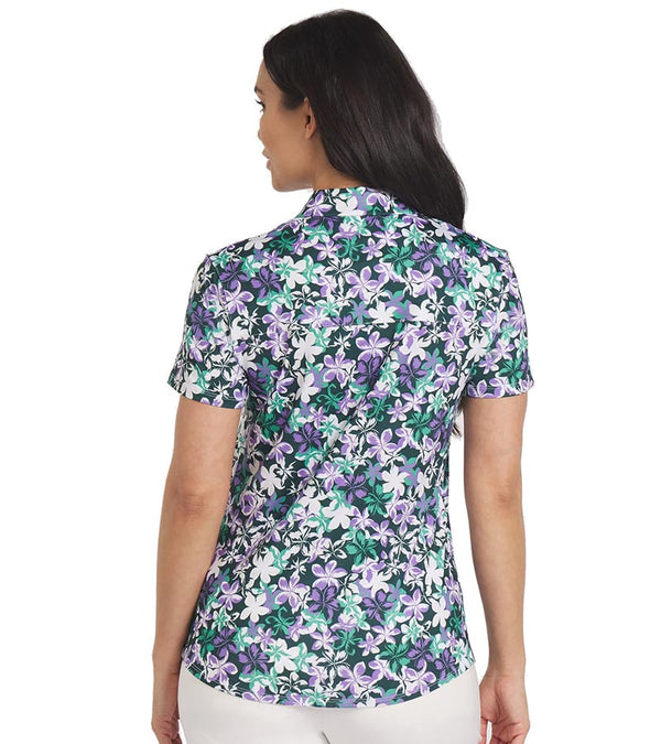 Puma Womens MATTR Lillie Golf Polo Shirt model back in Dark Myrtle / Lavender Alert featuring an all over smallish floral print with a classic polo collar and button placket for a sophisticated, sporty look. 