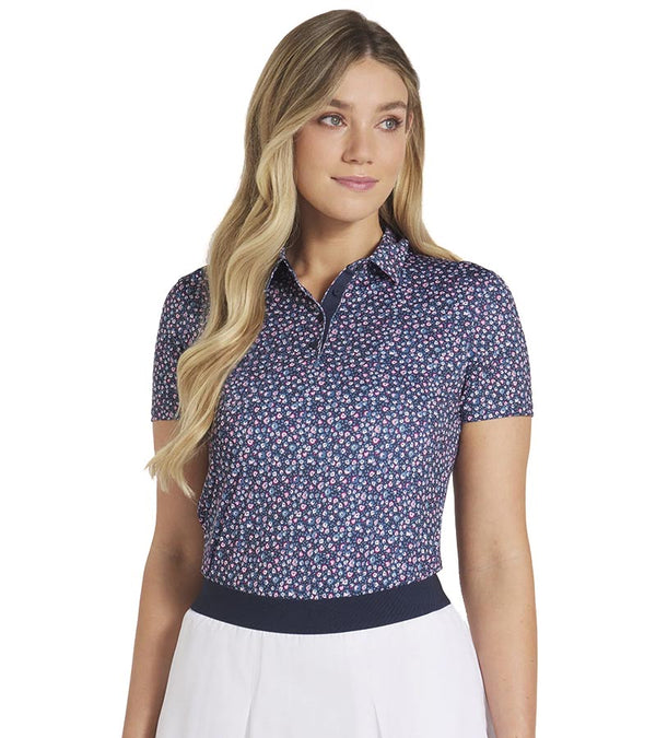 Puma Womens MATTR Lillie Golf Polo Shirt model front in Deep Navy / Magenta Gleam featuring all-over small floral print with an accent color for the inner collar and inner 4 button placket that adds a unique touch of elegance to this short sleeve golf shirt.