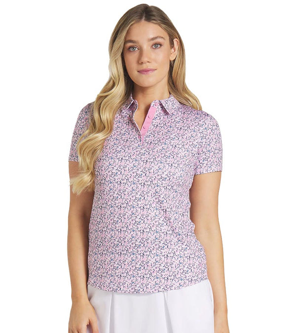 Puma Womens MATTR Lillie Golf Polo Shirt model front in Mauved Out / White Glow featuring all-over small floral print with an accent color for the inner collar and inner 4 button placket that adds a unique touch of elegance to this short sleeve golf shirt.