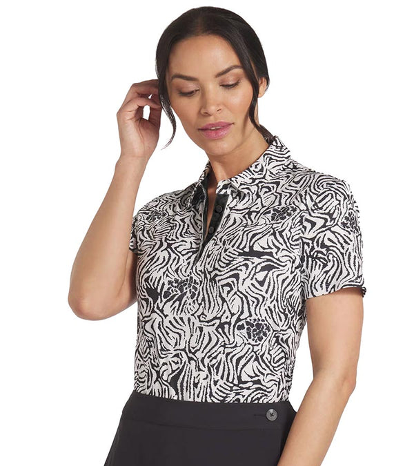 Puma Womens CLOUDSPUN Zebra Golf Polo Shirt model front in Warm White / Puma Black featuring a bold all over zebra pattern with a coordinating solid accent color for the inner collar and inner button placket.