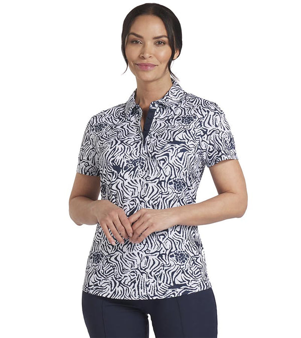 Puma Womens CLOUDSPUN Zebra Golf Polo Shirt model front in White Glow / Deep Navy featuring a bold all over zebra pattern with a coordinating solid accent color for the inner collar and inner button placket.