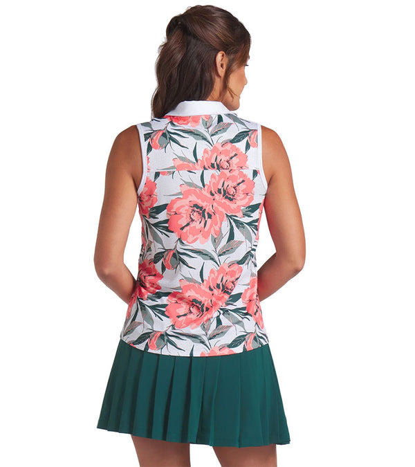 Puma MATTR Hadley Sleeveless Womens Golf Polo Shirt - partial model, back view  in White Glow / Peach Frost an  an eye-catching floral print in vibrant coral pink and lush green tones