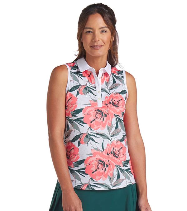 Puma MATTR Hadley Sleeveless Womens Golf Polo Shirt - partial model, front view   in White Glow / Peach Frost an  an eye-catching floral print in vibrant coral pink and lush green tones