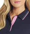 Puma Womens Pique Tipped Golf Polo Shirt shirt in solid Deep Navy with closeup of neckline featuring a classic collar with pink & blue contrast piping and a pink three-button inner placket.