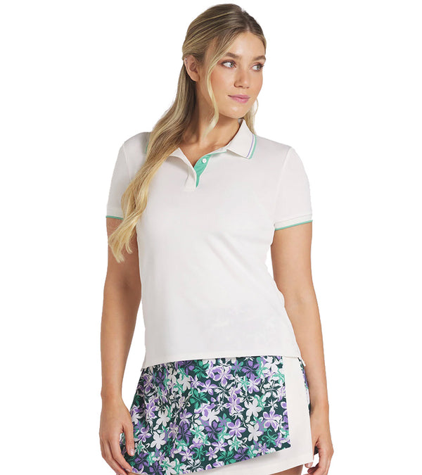 Puma Womens Pique Tipped Golf Polo Shirt - model front in solid Warm White featuring a classic collar with green & lavender contrast piping and a green three-button inner placket.