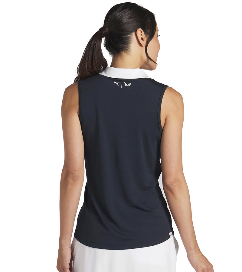 Puma Womens Volition Piped Sleeveless Golf Polo model-back in Deep Navy features a classic sleeveless design with distinctive contrast details with a contrasting collar and signature red piping along the V-neck placket.