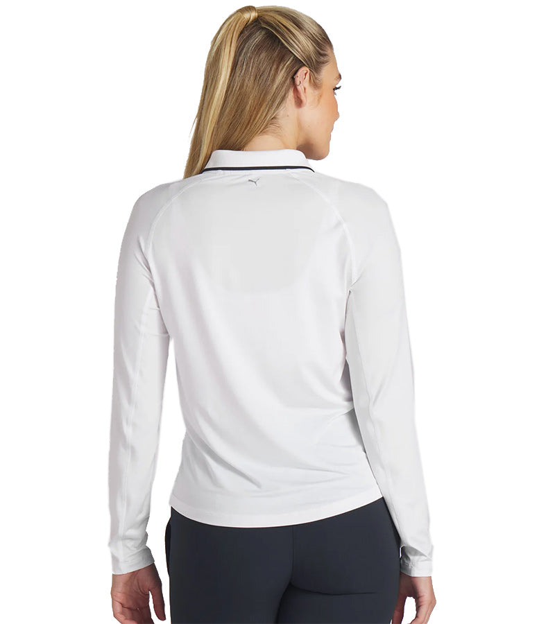 PUMA Women's YouV Long Sleeve Golf Polo shirt model backin solid White Glow with model front featuring a classic zippered placket and contrast  navy piping details on the collar.