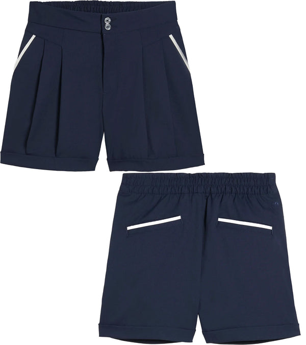 Puma x AP Solid Women’s Golf Shorts- partial model -front & back in Deep Navy with contrast white piping on the pockets 