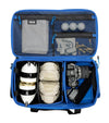 Blue travel bag with compartments containing various golf items such as tees, balls, glove, shoes, towel, and camera equipment.