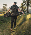 The Sunday Golf El Camino mid-size Stand Golf Bag in Matte Black - carried by a male golfer on the course