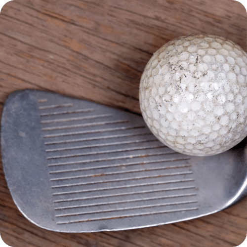 dirty golf club and ball