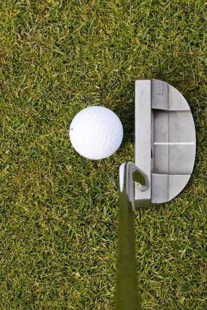 golf ball lined up with putter