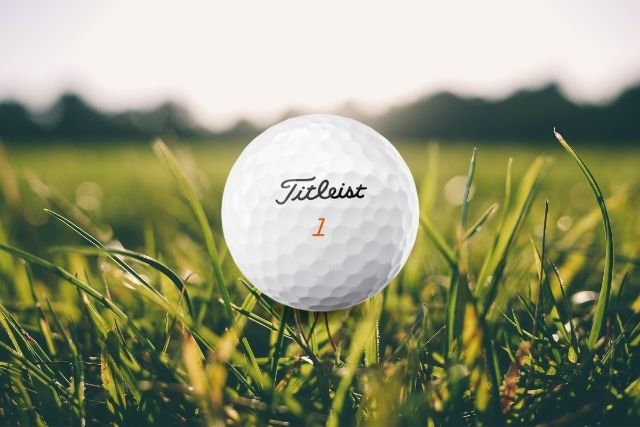 Titleist velocity ball with grass background