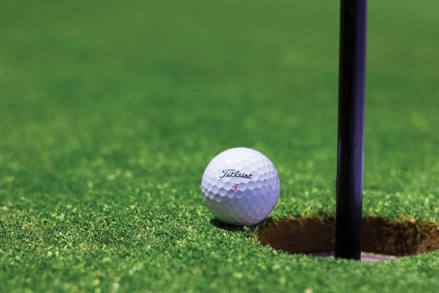 Titleist velocity golf ball near hole