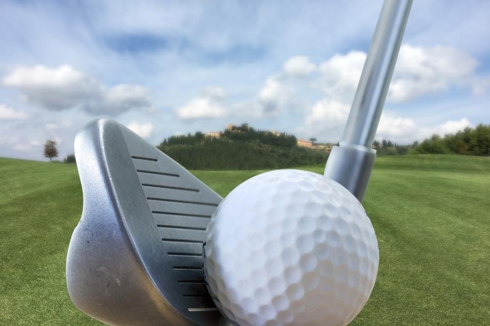 golf iron behind ball