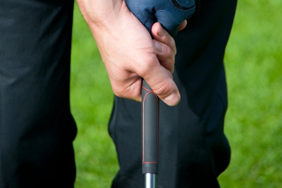 golfer holding a club with clean golf grips