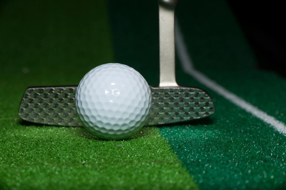 forgiving putter behind a golf ball