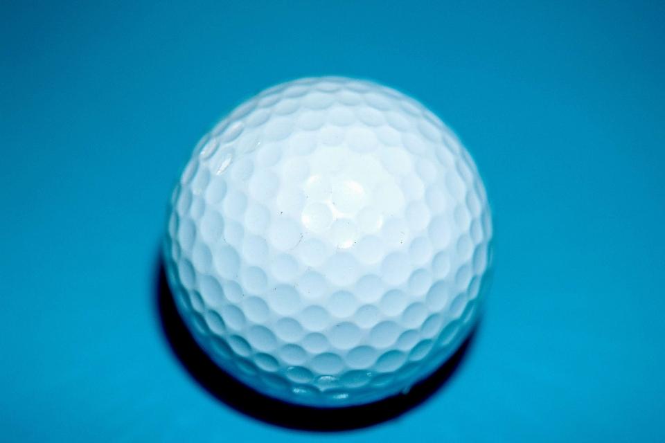 golf ball dimples with blue background