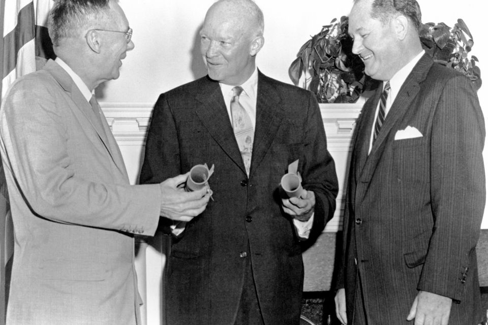 Dwight D. Eisenhower speaking with two people