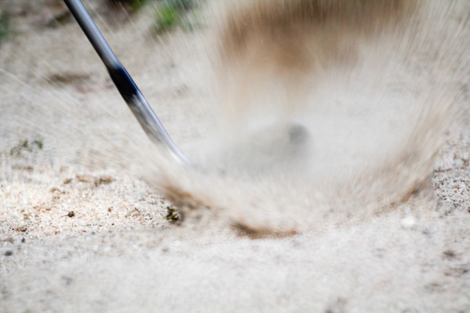 sand wedge hitting golf ball