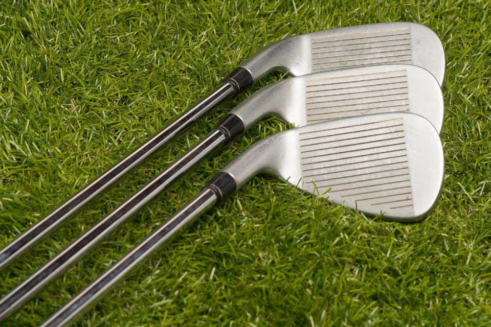 Three blade irons laying in the grass