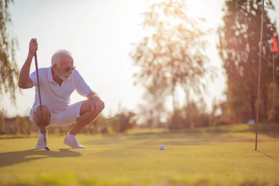 Old man playing golf alone without any distractions