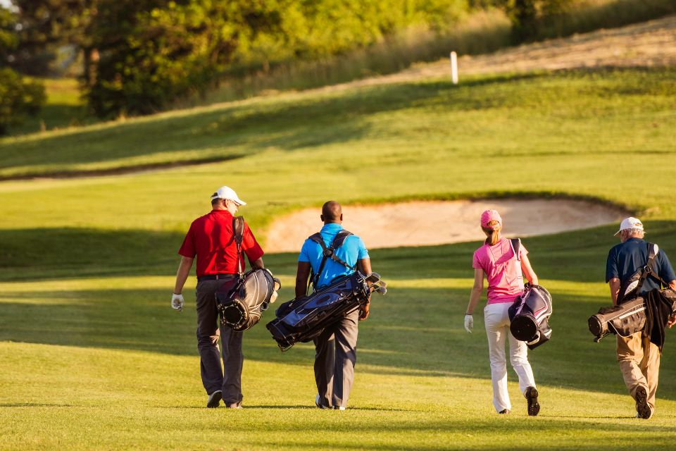 Golfers playing with a group of people