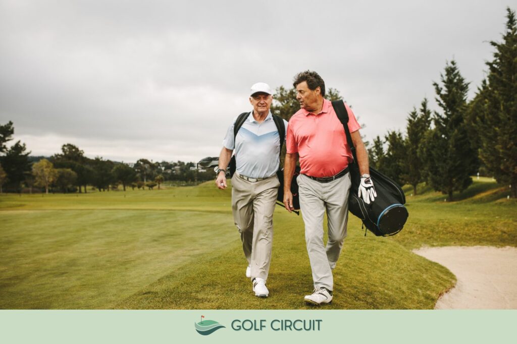 two older golfers walking on the course